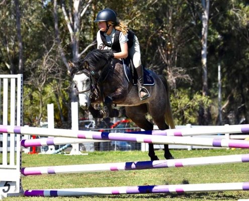 Olivia riding at a showjumping competition
